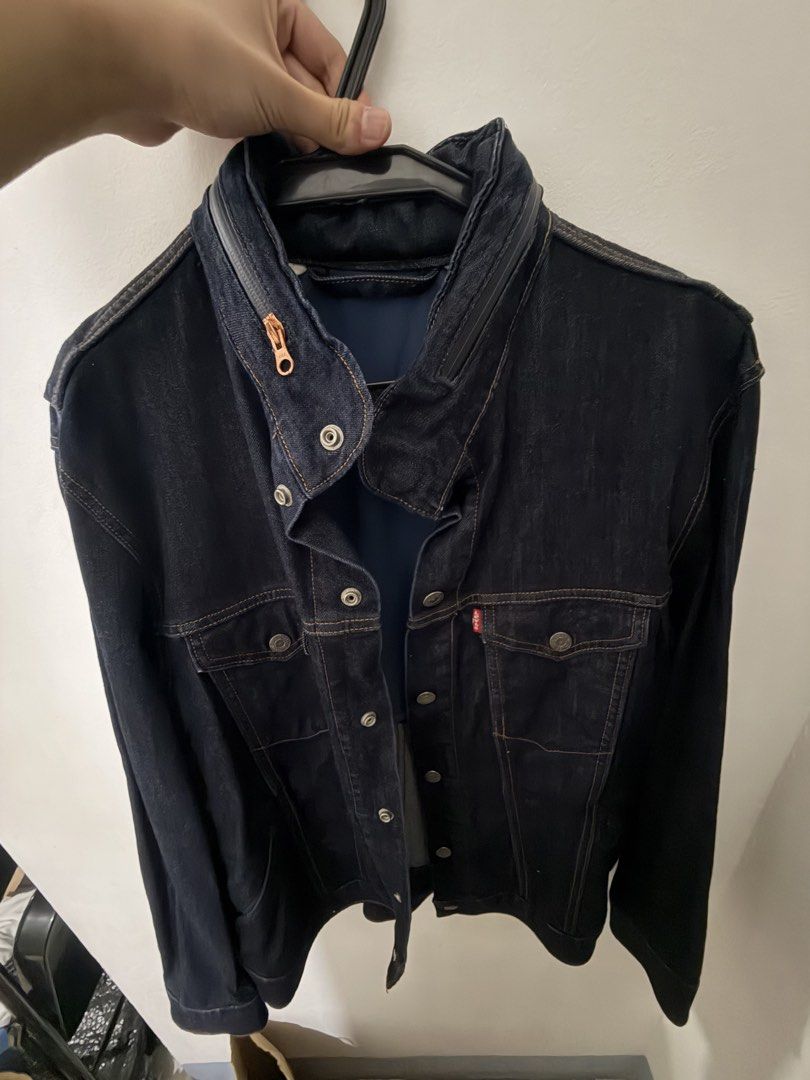 Levi's Denim Jacket Dark Wash (Category: Coats, Jackets and Outerwear) located in Quezon City. Submitted by clareb (Listing ID 1468963405, Image 2). Description: - Used once - Brand: Levi's - Wash: Dark wash denim - Features: Button-up front, metallic hardware, dual chest pockets - Unique Detail: Zipper accent along the back edge of the collar - Stitching: Contrast orange stitching throughout - Fit/Style: Great layering staple piece - Origin: Mad
