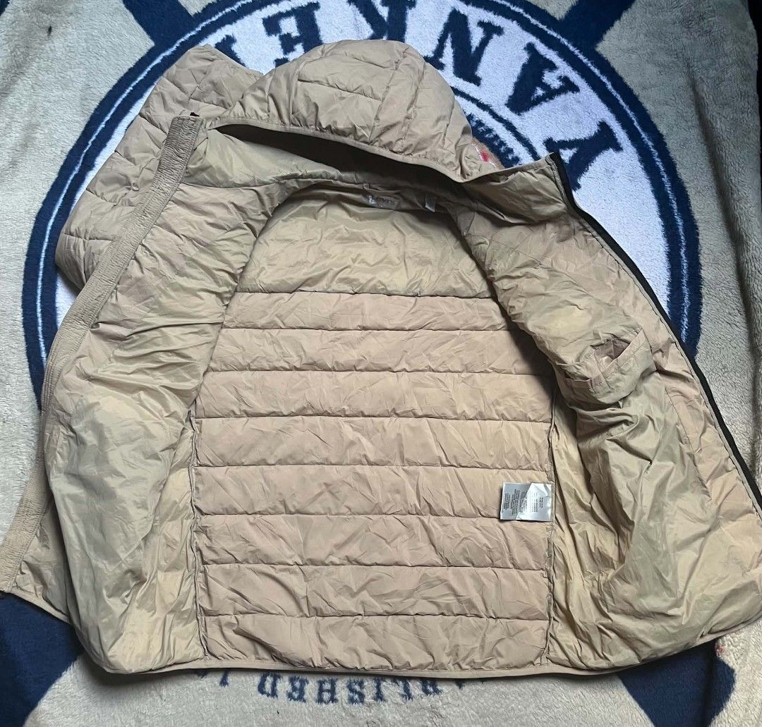 Levi's Quilted Puffer Hooded Jacket Beige (Category: Coats, Jackets and Outerwear) located in Manila. Submitted by dildojrjon00316 (Listing ID 1468998845, Image 3). Description: - Brand: Levi's - Color: Classic Beige - Style: Quilted puffer jacket with attached hood - Closure: Full front zip - Pockets: 2 snap-button chest pockets with red tab, 2 zippered lower hand pockets, and 1 inner pocket - Details: Elastic cuffs for extra warmth and snug fit