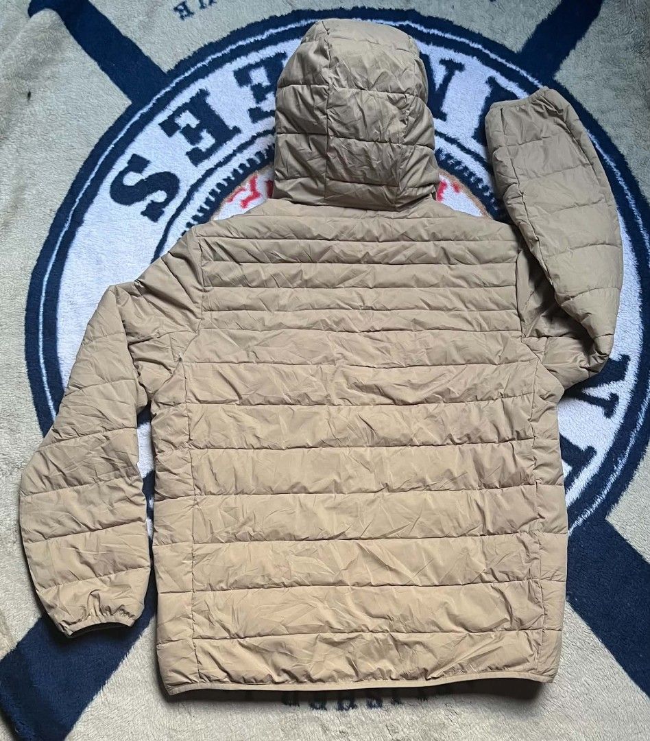 Levi's Quilted Puffer Hooded Jacket Beige (Category: Coats, Jackets and Outerwear) located in Manila. Submitted by dildojrjon00316 (Listing ID 1468998845, Image 2). Description: - Brand: Levi's - Color: Classic Beige - Style: Quilted puffer jacket with attached hood - Closure: Full front zip - Pockets: 2 snap-button chest pockets with red tab, 2 zippered lower hand pockets, and 1 inner pocket - Details: Elastic cuffs for extra warmth and snug fit