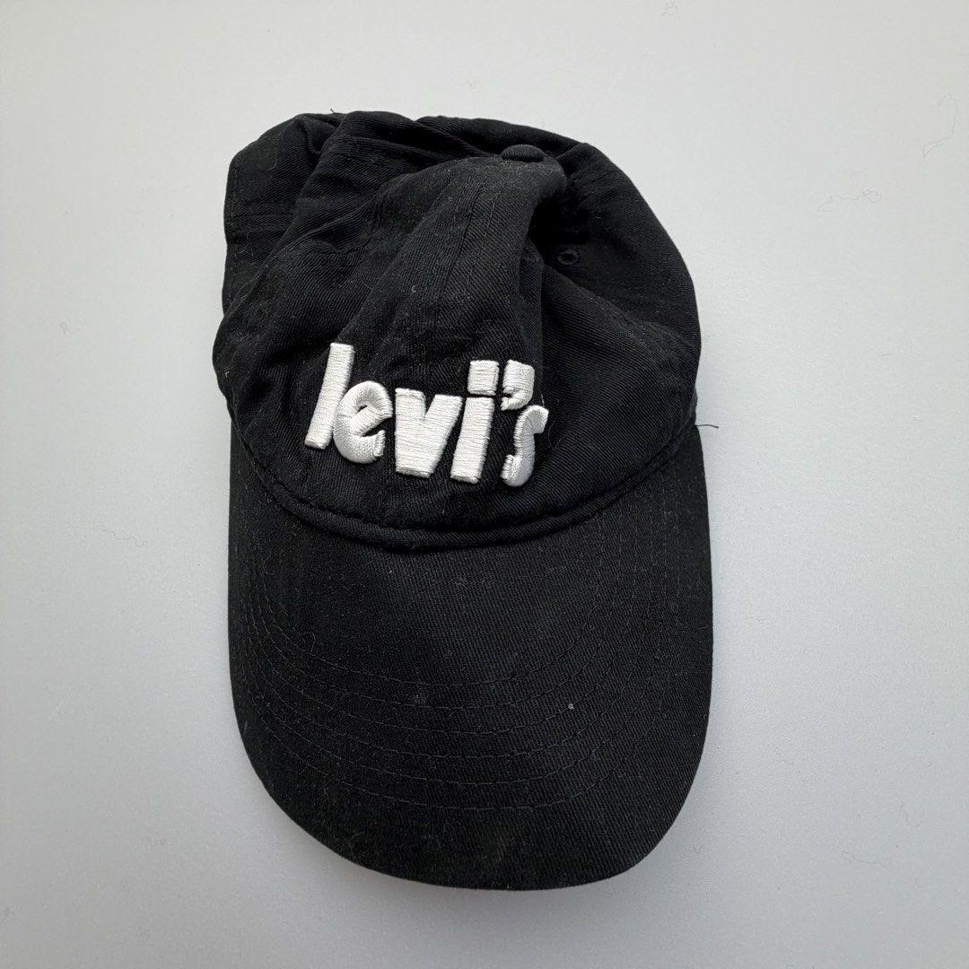 Levi’s Youth Black Embroidered Logo Baseball Cap Adjustable (Category: Caps & Hats) located in San Juan City. Submitted by vc828 (Listing ID 1469102902, Image 1). Description: Levi’s black cotton baseball cap featuring a bold white embroidered Levi’s logo on the front. Classic curved brim with an adjustable Velcro strap and signature Levi’s red tab at the back. DETAILS • Brand: Levi’s • Color: Black / White • Size: Youth, adjustable (53–58 cm) • 