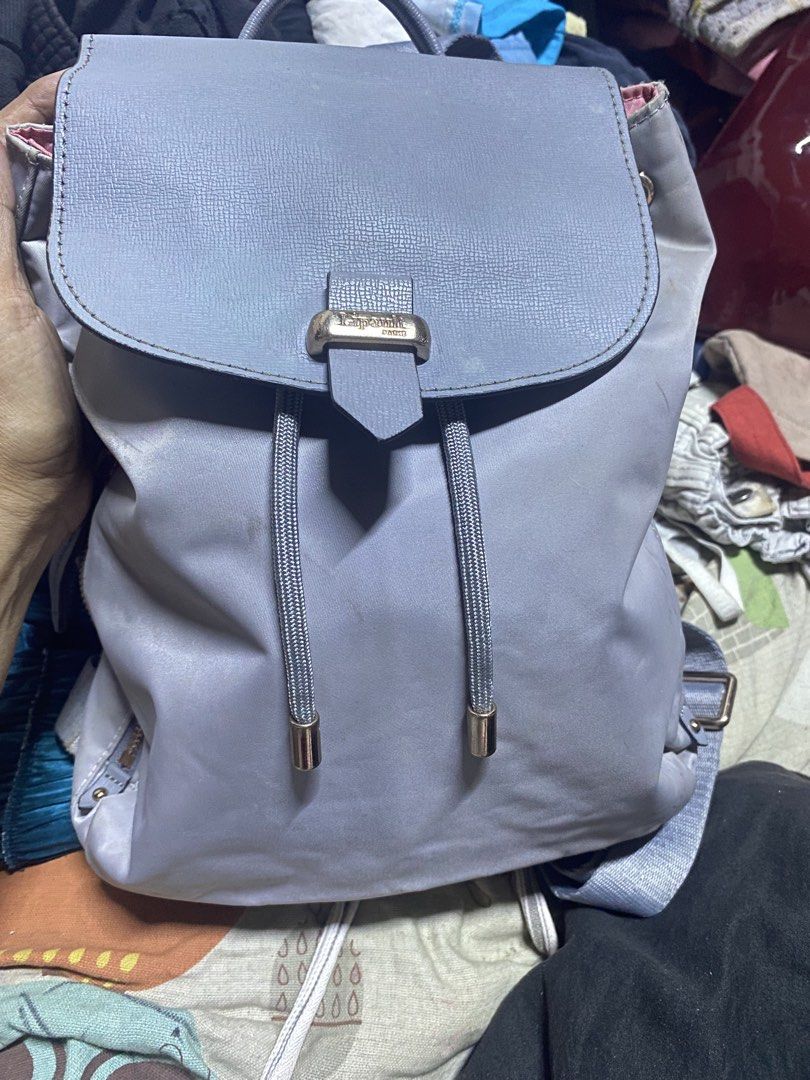Lipault Paris Light Grey Backpack (Category: Backpacks) located in Manila. Submitted by noemiaspa1702 (Listing ID 1469079784, Image 1). Description: - Authentic Lipault Paris backpack - Color: Light grey with vibrant pink interior lining - Closure: Flap top with secure metal clasp and drawstring pull - Storage: Multiple interior pockets, including a zippered compartment and a velcro tab pocket - Comfort: Adjustable shoulder straps for a custom fi