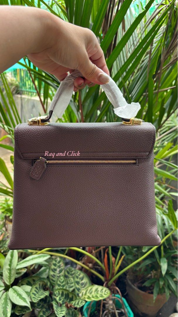 Little Bunny Clara - with 3 straps (Category: Luxury Bags & Wallets) located in Quezon. Submitted by mommynizooeyatichiro (Listing ID 1468981536, Image 2). Description: - Color/Material: Textured brown with gold-tone hardware - Closure: Top flap with magnetic snap buttons - Pockets: Double front zipper pockets and interior slip pocket - Interior: Clean dark plum lining with a spacious compartment - Condition: Brand new, handle still wrapped in pr