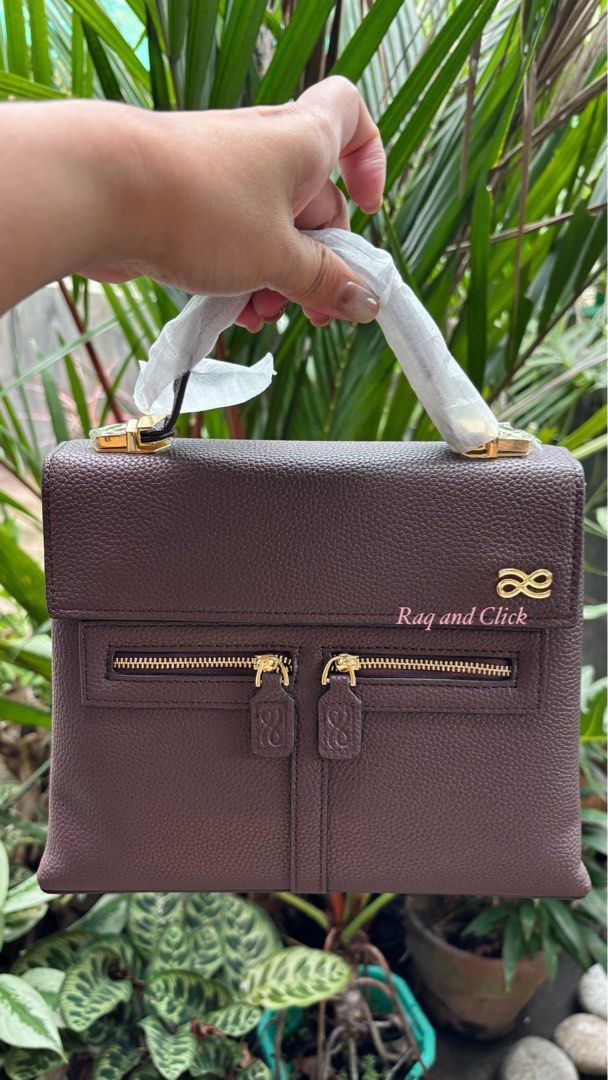 Little Bunny Clara - with 3 straps (Category: Luxury Bags & Wallets) located in Quezon. Submitted by mommynizooeyatichiro (Listing ID 1468981536, Image 1). Description: - Color/Material: Textured brown with gold-tone hardware - Closure: Top flap with magnetic snap buttons - Pockets: Double front zipper pockets and interior slip pocket - Interior: Clean dark plum lining with a spacious compartment - Condition: Brand new, handle still wrapped in pr