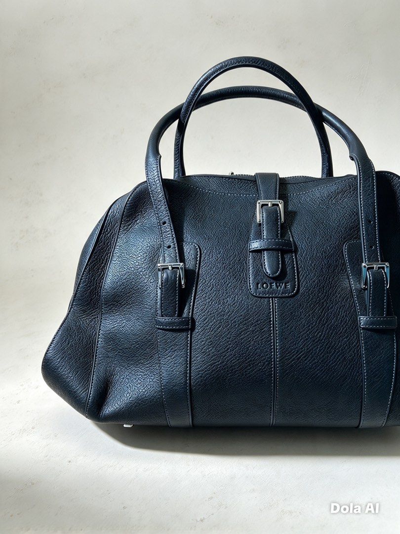 Loewe Black Leather Handbag (Category: Luxury Bags & Wallets) located in Aroroy. Submitted by mahinaanlangs (Listing ID 1469029170, Image 2). Description: Loewe Black Leather Handbag Legit Large Size Very Good Condition Issue:Kunti Gasgas At Maliit na punit sa loob Pero Bagong Bago pa sya sa labas 12k+Sf .