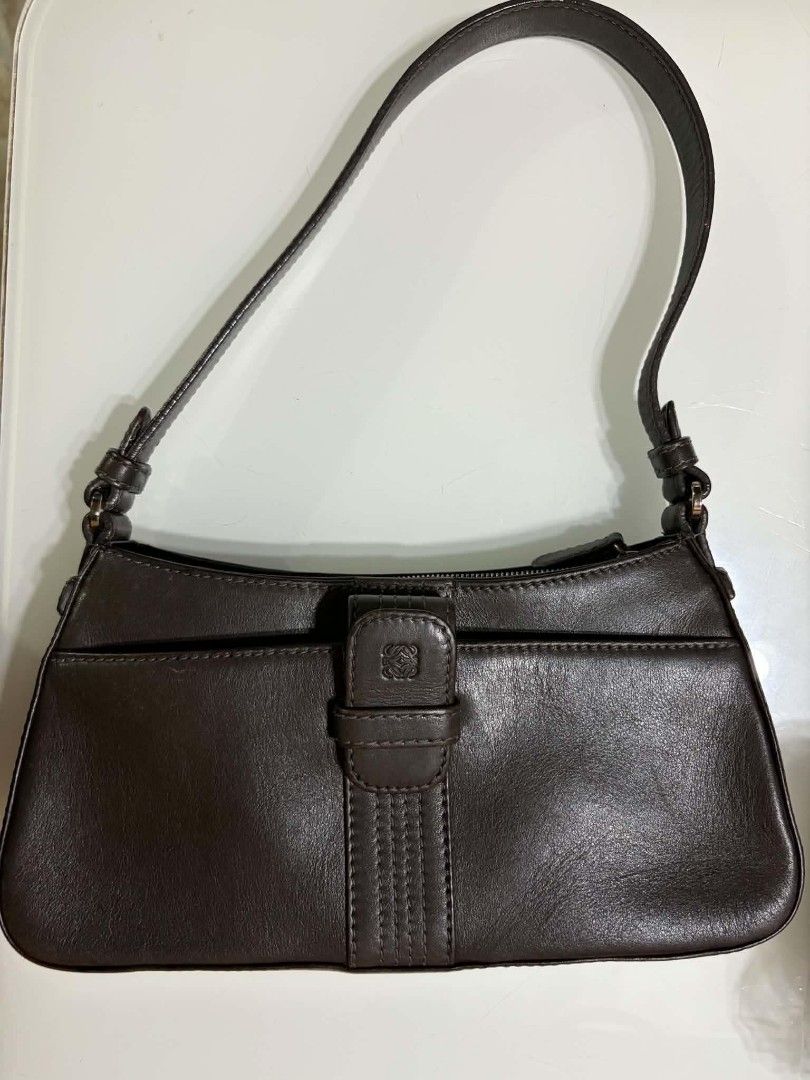 Loewe Brown Leather Shoulder Bag (Category: Luxury Bags & Wallets) located in Naga. Submitted by mrwisethrifter (Listing ID 1469083031, Image 1). Description: - Brand: Loewe - Material: Rich dark brown leather - Condition: Minimal wear, excellent everyday bag - Exterior: Slip pocket with branded strap closure - Interior: Clean fabric lining with secure zip-top opening - Style: Compact silhouette with a single shoulder strap.