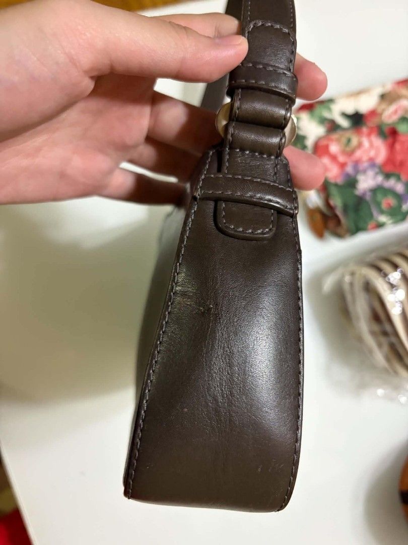 Loewe Brown Leather Shoulder Bag (Category: Luxury Bags & Wallets) located in Naga. Submitted by mrwisethrifter (Listing ID 1469083031, Image 3). Description: - Brand: Loewe - Material: Rich dark brown leather - Condition: Minimal wear, excellent everyday bag - Exterior: Slip pocket with branded strap closure - Interior: Clean fabric lining with secure zip-top opening - Style: Compact silhouette with a single shoulder strap.