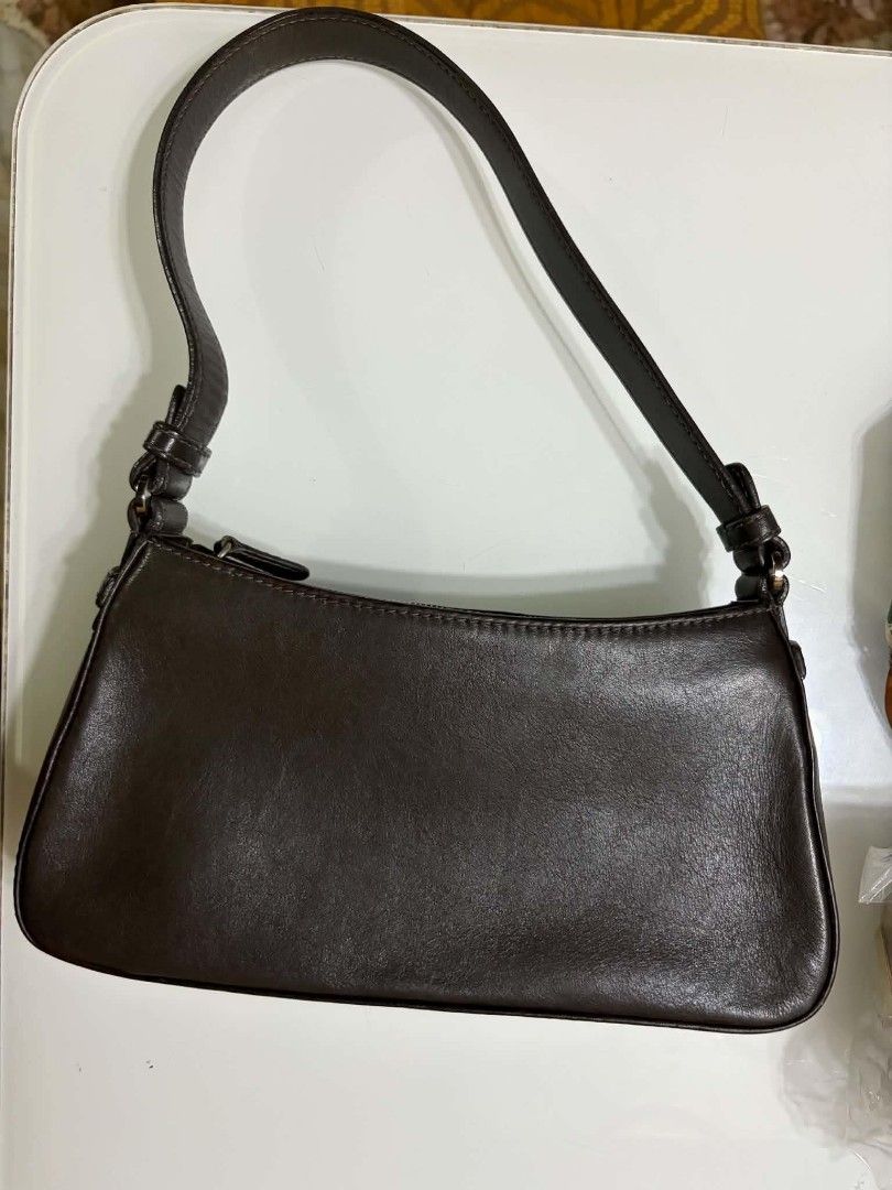 Loewe Brown Leather Shoulder Bag (Category: Luxury Bags & Wallets) located in Naga. Submitted by mrwisethrifter (Listing ID 1469083031, Image 2). Description: - Brand: Loewe - Material: Rich dark brown leather - Condition: Minimal wear, excellent everyday bag - Exterior: Slip pocket with branded strap closure - Interior: Clean fabric lining with secure zip-top opening - Style: Compact silhouette with a single shoulder strap.