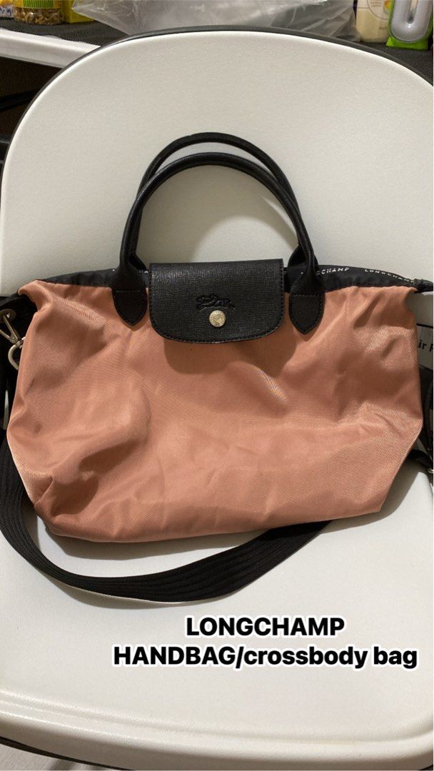 Longchamp handbag crossbody bag (Category: Luxury Bags & Wallets) located in Silang. Submitted by princess_jasmin (Listing ID 1469105692, Image 1). Description: Longchamp bag in pink with contrasting black handles and flap - Comes with an adjustable black crossbody strap for versatile wear - Secure zip top closure to keep your belongings safe - RUSH shipping available, message us to order!.
