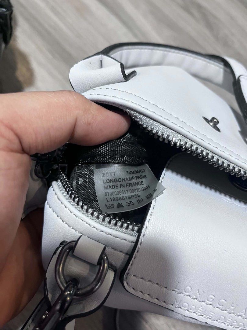 Longchamp Le Pliage Cuir Extra Small White Leather Bag (Category: Cross-body Bags) located in Dagupan City. Submitted by fahionista1988 (Listing ID 1469048908, Image 3). Description: - Brand: Longchamp - Color: Clean white leather - Style: Mini handbag with top handles and detachable crossbody strap - Hardware: Gunmetal - Closure: Zip closure with iconic horse logo snap flap - Authenticity: Includes serial numbers and 'Made in France' tag - Condi