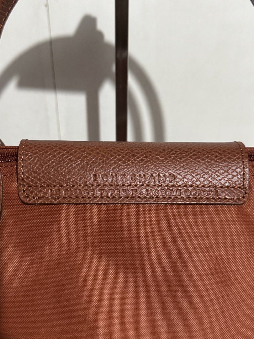 Longchamp Le Pliage Medium Tote Bag Cognac (Category: Luxury Bags & Wallets) located in Manila. Submitted by reinjoseph (Listing ID 1468985587, Image 3). Description: - Brand: Longchamp Le Pliage - Size: Medium - Color: Classic Brown - Material: Durable nylon body with leather handles and flap - Features: Iconic foldable design, dual top handles, snap button flap, zippered top closure, and interior slip pocket - Origin: Made in Tunisia - Conditio