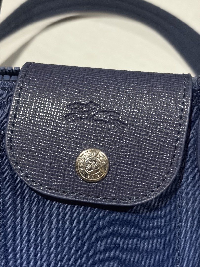 Longchamp navy small doctor's bag (Category: Cross-body Bags) located in Manila. Submitted by bbygirly (Listing ID 1469102637, Image 2). Description: - NGA, Preloved only - Super cute~ Barrel le pliage satchel style - Used twice but stained na pls see pic! - Adjustable strap tags: longchamp, office siren, y2k, vintage.