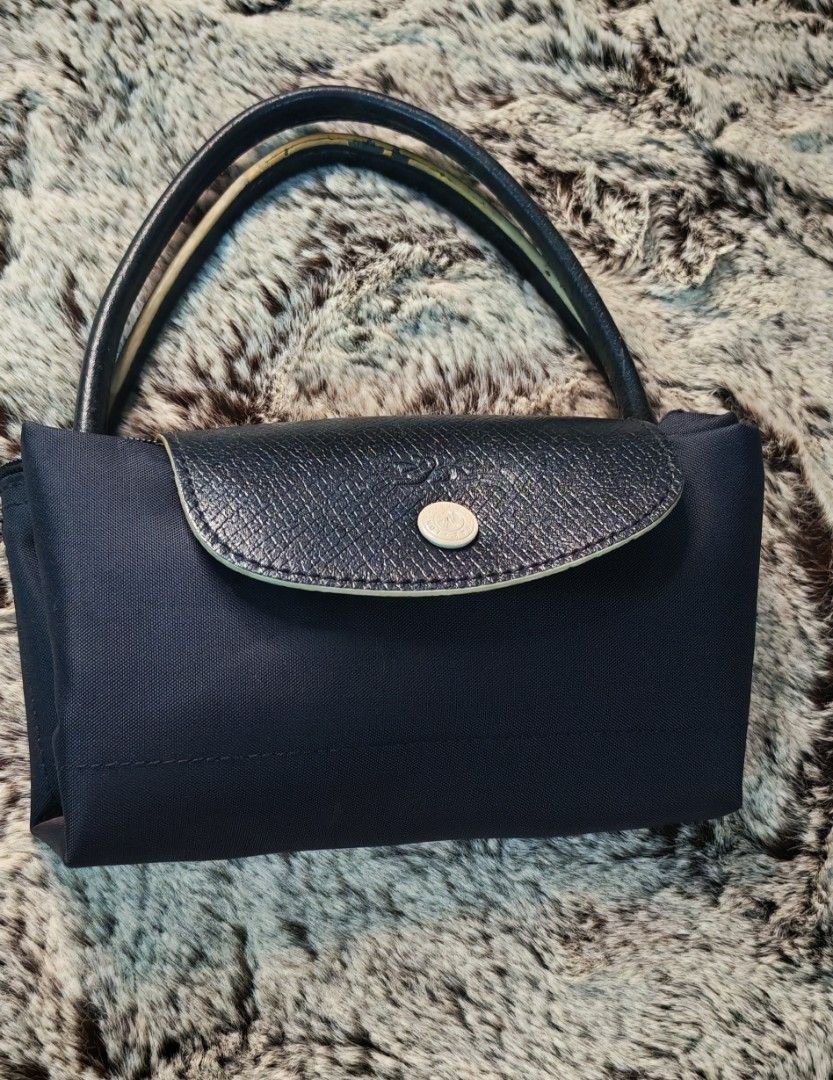 Longchamp Paris Tote Bag black (Category: Luxury Bags & Wallets) located in Caloocan City. Submitted by miyaka_lm (Listing ID 1469088526, Image 1). Description: - Authentic Longchamp tote bag in d - Medium size, ideal for daily use - Classic durable nylon body with leather flap closure and handles - Elegant gold-tone hardware and snap button - Signature embroidered jockey logo on the front - Interior tag shows model details and origin - Condition