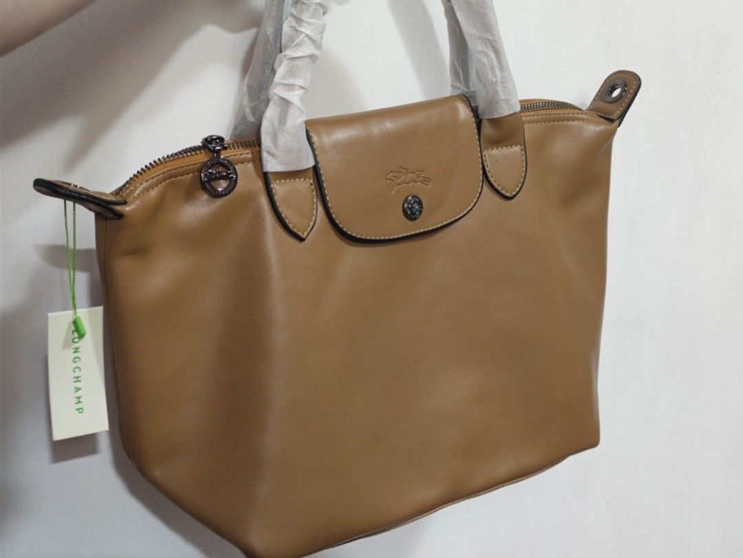 Longchamp Soft leather with nylon strap (Category: Luxury Bags & Wallets) located in Quezon City. Submitted by pprzi_89 (Listing ID 1467890858, Image 1). Description: + shipping fee - Top short handle - Nylon adjustable shoulder strap - Condition: Brand new.