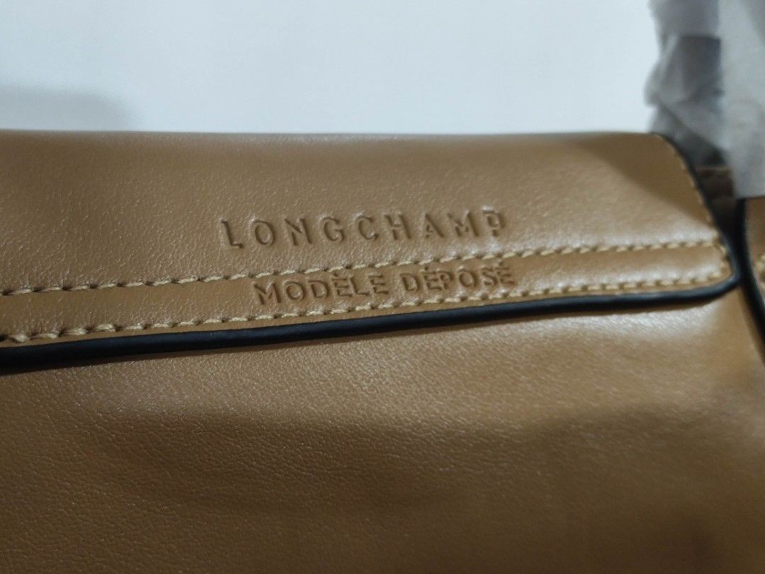 Longchamp Soft leather with nylon strap (Category: Luxury Bags & Wallets) located in Quezon City. Submitted by pprzi_89 (Listing ID 1467890858, Image 3). Description: + shipping fee - Top short handle - Nylon adjustable shoulder strap - Condition: Brand new.
