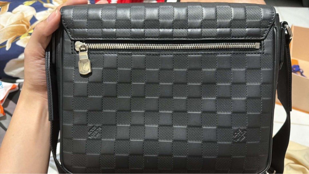 LV Messenger Bag (Category: Luxury Bags & Wallets) located in Quezon City. Submitted by khayedee (Listing ID 1469136837, Image 3). Description: - Authentic Louis Vuitton messenger bag - Premium black Damier Infini leather with embossed LV logo - Secure structured flap closure with clean side stitching - Practical back zipper pocket for quick access - Adjustable black fabric strap with sleek silver-tone hardware - Includes original orange box - Gu