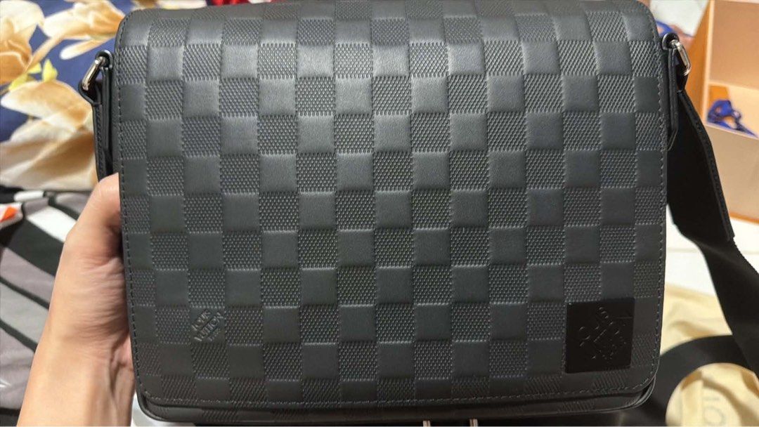 LV Messenger Bag (Category: Luxury Bags & Wallets) located in Quezon City. Submitted by khayedee (Listing ID 1469136837, Image 2). Description: - Authentic Louis Vuitton messenger bag - Premium black Damier Infini leather with embossed LV logo - Secure structured flap closure with clean side stitching - Practical back zipper pocket for quick access - Adjustable black fabric strap with sleek silver-tone hardware - Includes original orange box - Gu