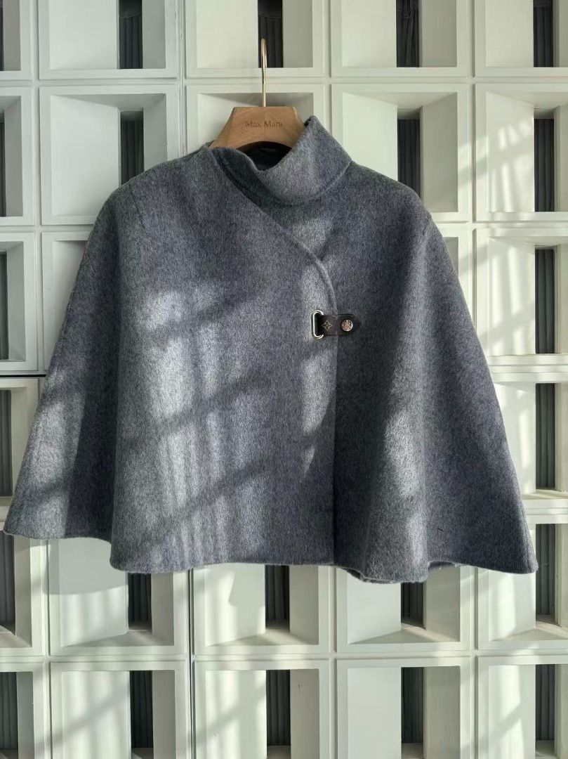 Louis Vuitton Grey Monogram Wool Cape (Category: Luxury Apparel) located in Pasay City. Submitted by prekajdasi85081 (Listing ID 1469024038, Image 2). Description: - Color/Material: Premium grey wool, very warm and cozy - Design: Open drape sleeveless cape with mock neck collar - Interior: Features classic monogram pattern throughout - Closure: Single black leather strap with metal hardware - Condition: Clean exterior, no flaws, stored in a smoke