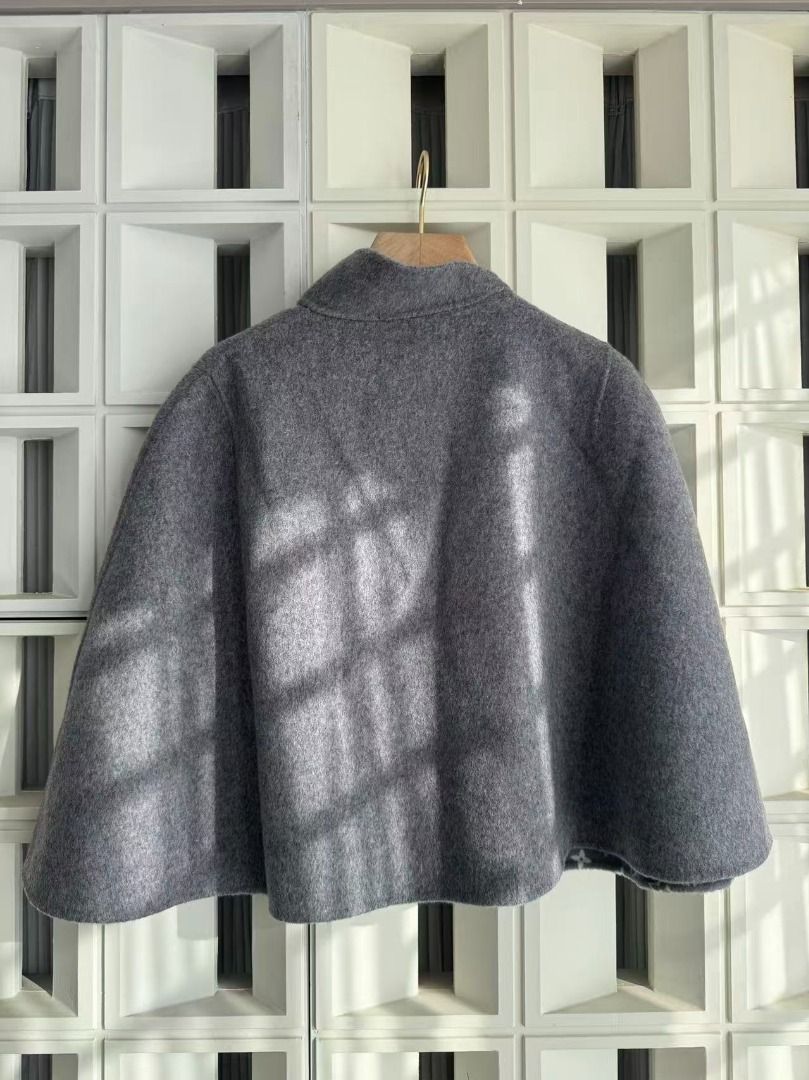 Louis Vuitton Grey Monogram Wool Cape (Category: Luxury Apparel) located in Pasay City. Submitted by prekajdasi85081 (Listing ID 1469024038, Image 3). Description: - Color/Material: Premium grey wool, very warm and cozy - Design: Open drape sleeveless cape with mock neck collar - Interior: Features classic monogram pattern throughout - Closure: Single black leather strap with metal hardware - Condition: Clean exterior, no flaws, stored in a smoke