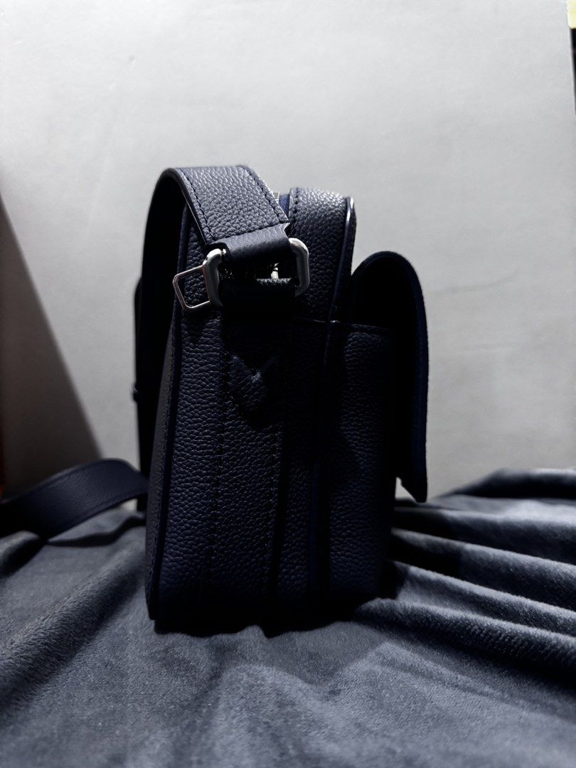 Louis Vuitton Messenger Bag (Category: Luxury Bags & Wallets) located in Caloocan City. Submitted by davidgenec64903 (Listing ID 1468979192, Image 3). Description: - Authentic Louis Vuitton dark blue textured leather messenger bag - Adjustable shoulder strap with sleek silver-tone hardware - Front flap pocket featuring debossed LV logo - Secure main zip compartment with clean fabric lining - Interior leather tag stamped Louis Vuitton Paris Made i