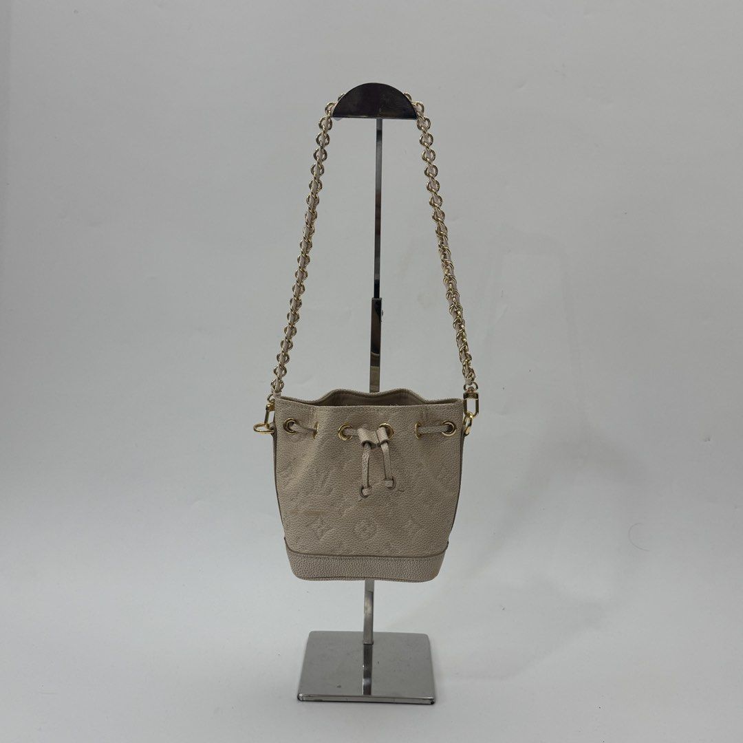 Louis Vuitton Monogram Empreinte Leather Bucket Bag Beige (Category: Luxury Bags & Wallets) located in Manila. Submitted by wisecloud_1b4b3c (Listing ID 1469027913, Image 3). Description: - Louis Vuitton bucket bag in beige Monogram Empreinte leather - Made in France with luxury gold-tone hardware - Secure drawstring closure with matching leather lace - Stylish chain shoulder strap featuring a comfortable leather shoulder guard - Compact and prac