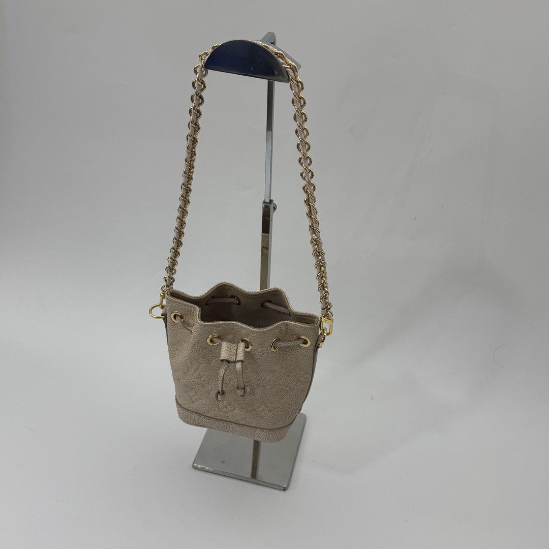 Louis Vuitton Monogram Empreinte Leather Bucket Bag Beige (Category: Luxury Bags & Wallets) located in Manila. Submitted by wisecloud_1b4b3c (Listing ID 1469027913, Image 2). Description: - Louis Vuitton bucket bag in beige Monogram Empreinte leather - Made in France with luxury gold-tone hardware - Secure drawstring closure with matching leather lace - Stylish chain shoulder strap featuring a comfortable leather shoulder guard - Compact and prac