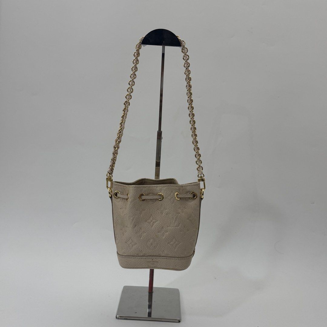 Louis Vuitton Monogram Empreinte Leather Bucket Bag Beige (Category: Luxury Bags & Wallets) located in Manila. Submitted by wisecloud_1b4b3c (Listing ID 1469027913, Image 1). Description: - Louis Vuitton bucket bag in beige Monogram Empreinte leather - Made in France with luxury gold-tone hardware - Secure drawstring closure with matching leather lace - Stylish chain shoulder strap featuring a comfortable leather shoulder guard - Compact and prac
