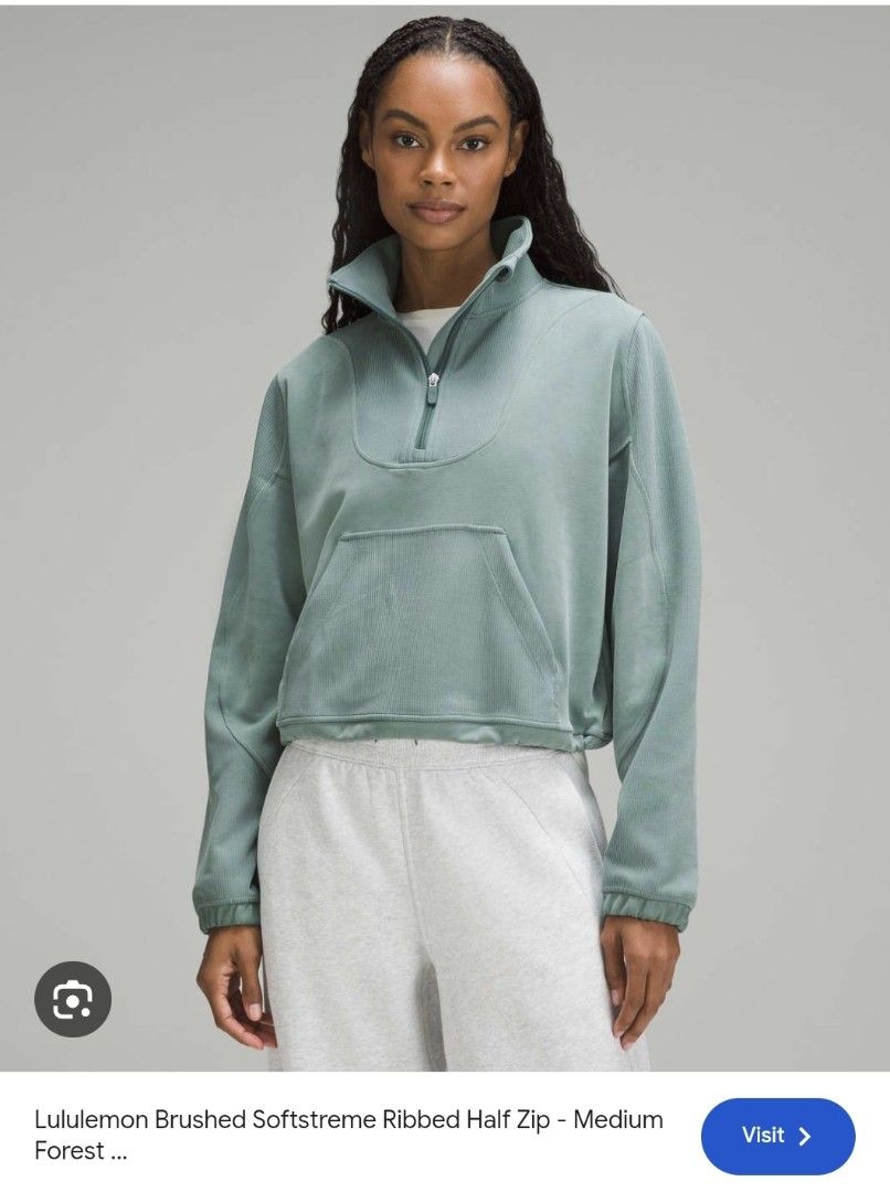 Lululemon Brushed Softstreme Ribbed Half Zip (Category: Activewear) located in Quezon City. Submitted by sashasarisarishoppe (Listing ID 1469013569, Image 3). Description: - Brand: Lululemon - Style: Brushed Softstreme Ribbed Half Zip - Color: Medium Forest Green - Fit: Cropped with adjustable drawcord hem - Features: High collar, half-zip closure, front kangaroo pocket, and subtle tonal logo on back neck - Material: Ultra-soft, textured ribbed f