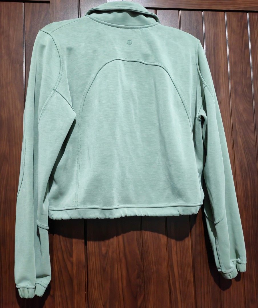 Lululemon Brushed Softstreme Ribbed Half Zip (Category: Activewear) located in Quezon City. Submitted by sashasarisarishoppe (Listing ID 1469013569, Image 2). Description: - Brand: Lululemon - Style: Brushed Softstreme Ribbed Half Zip - Color: Medium Forest Green - Fit: Cropped with adjustable drawcord hem - Features: High collar, half-zip closure, front kangaroo pocket, and subtle tonal logo on back neck - Material: Ultra-soft, textured ribbed f