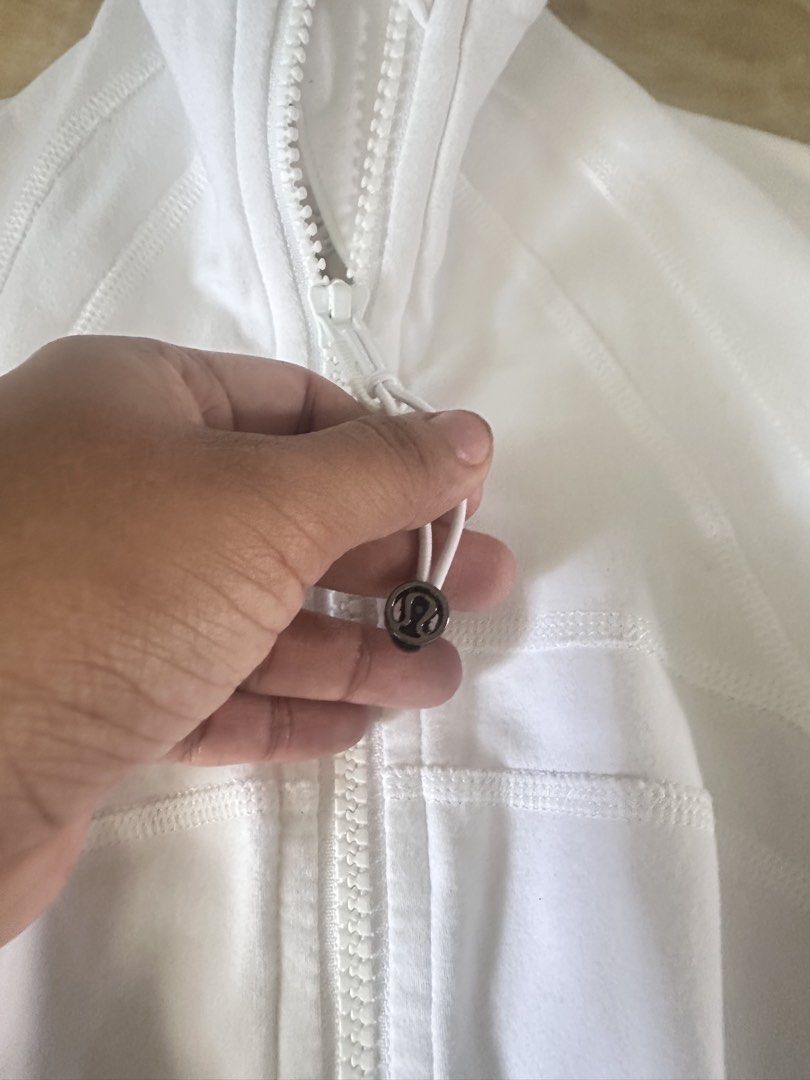 Lululemon Define Jacket White (Category: Coats, Jackets and Outerwear) located in Manila. Submitted by jessj30 (Listing ID 1468958410, Image 3). Description: - Brand: Lululemon - Style: Define Jacket - Color: White - Features: Thumbholes, secure zip pockets, stand-up collar, and signature logo zipper pull - Fabric: Soft, high-performance athletic material with shaping seam lines - Condition: Excellent - Perfect for: Gym workouts, running errands,