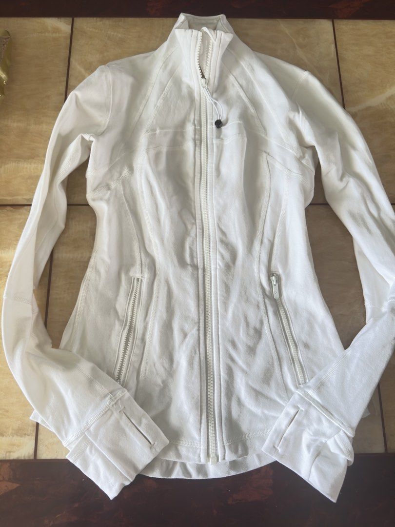 Lululemon Define Jacket White (Category: Coats, Jackets and Outerwear) located in Manila. Submitted by jessj30 (Listing ID 1468958410, Image 2). Description: - Brand: Lululemon - Style: Define Jacket - Color: White - Features: Thumbholes, secure zip pockets, stand-up collar, and signature logo zipper pull - Fabric: Soft, high-performance athletic material with shaping seam lines - Condition: Excellent - Perfect for: Gym workouts, running errands,