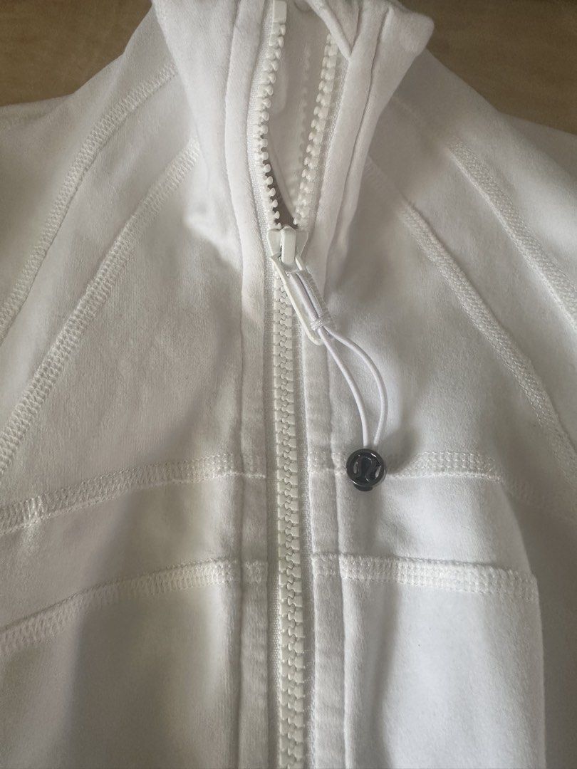 Lululemon Define Jacket White (Category: Coats, Jackets and Outerwear) located in Manila. Submitted by jessj30 (Listing ID 1468958410, Image 1). Description: - Brand: Lululemon - Style: Define Jacket - Color: White - Features: Thumbholes, secure zip pockets, stand-up collar, and signature logo zipper pull - Fabric: Soft, high-performance athletic material with shaping seam lines - Condition: Excellent - Perfect for: Gym workouts, running errands,