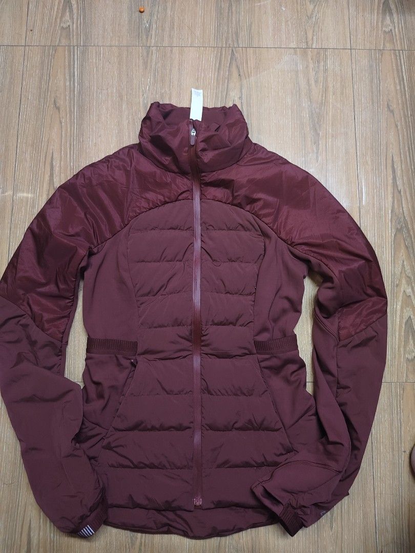 Lululemon Down Jacket Burgundy Maroon (Category: Coats, Jackets and Outerwear) located in Tacloban City. Submitted by soniaahom51096 (Listing ID 1468961038, Image 2). Description: Burgundy maroon zip-up jacket from Lululemon. Puffer style on chest and lower back with smooth fabric sleeves and side panels. High collar, full zip closure, and zippered hand pockets. Reflective Lululemon logo branding printed on the sleeve cuff alongside striped refle