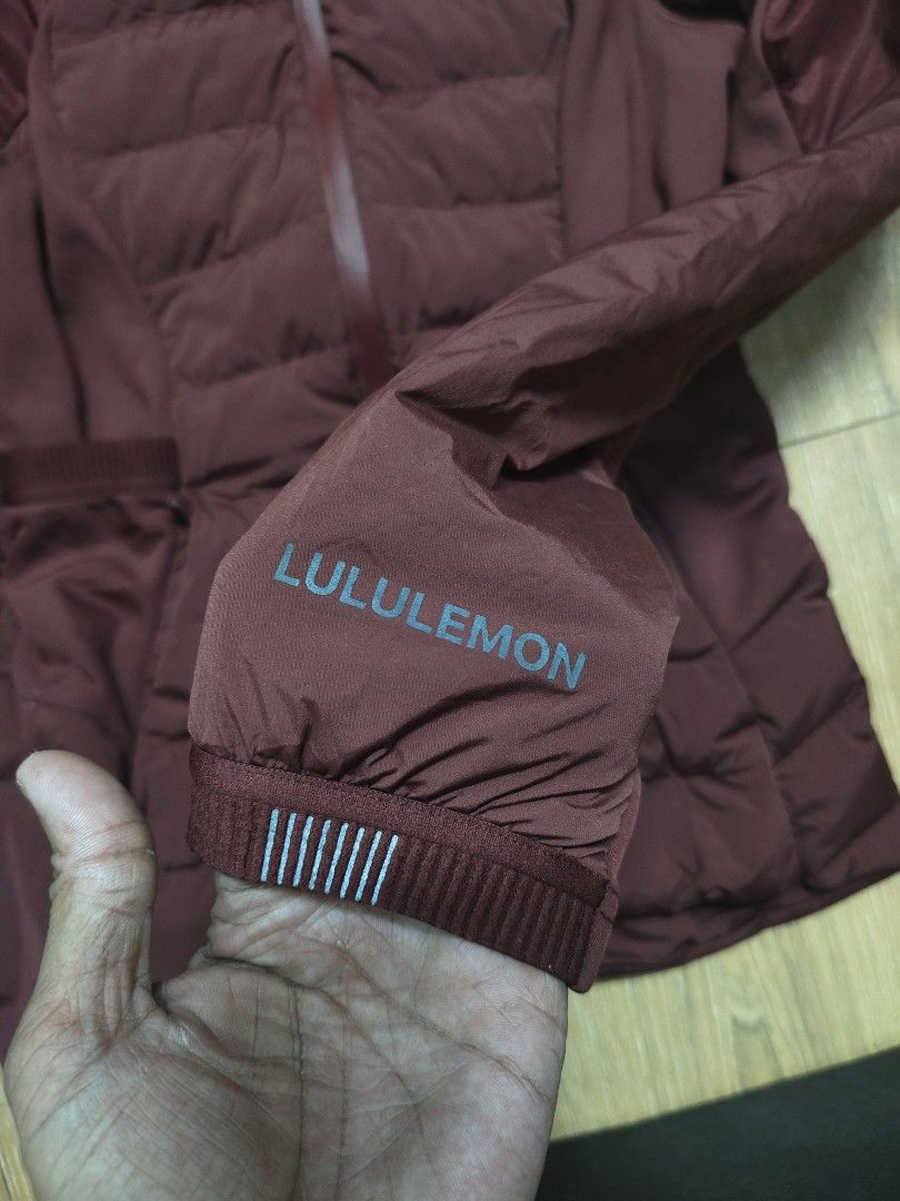 Lululemon Down Jacket Burgundy Maroon (Category: Coats, Jackets and Outerwear) located in Tacloban City. Submitted by soniaahom51096 (Listing ID 1468961038, Image 3). Description: Burgundy maroon zip-up jacket from Lululemon. Puffer style on chest and lower back with smooth fabric sleeves and side panels. High collar, full zip closure, and zippered hand pockets. Reflective Lululemon logo branding printed on the sleeve cuff alongside striped refle