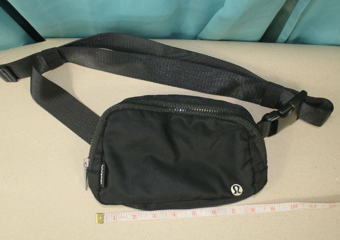 Lululemon Everywhere Belt Bag (Category: Beach Bags) located in Cebu City. Submitted by sinina.station (Listing ID 1468977504, Image 1). Description:  1L Standard Size)  Black with a silver/chrome logo  Water-repellent nylon body with a polyester liner  Includes an exterior zippered security pocket on the back, internal mesh slip compartments, and an adjustable strap with elastic loops Pre-owned. .