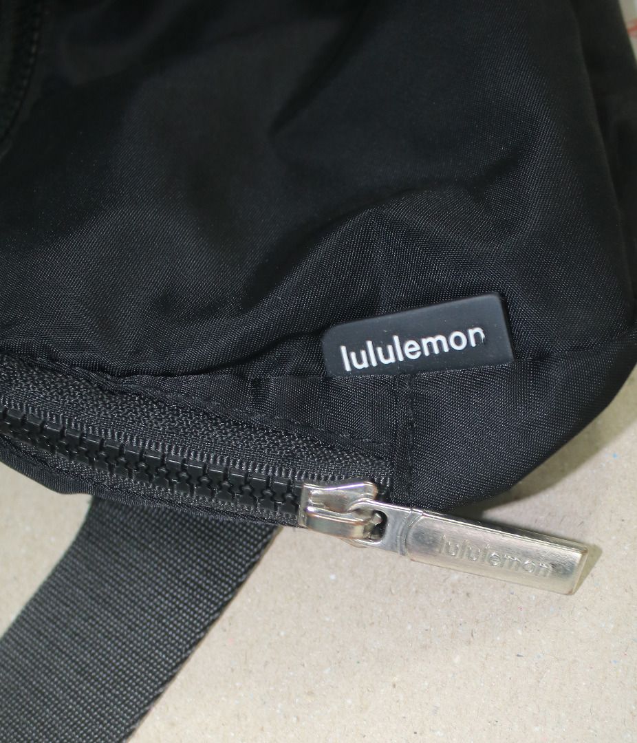 Lululemon Everywhere Belt Bag (Category: Beach Bags) located in Cebu City. Submitted by sinina.station (Listing ID 1468977504, Image 2). Description:  1L Standard Size)  Black with a silver/chrome logo  Water-repellent nylon body with a polyester liner  Includes an exterior zippered security pocket on the back, internal mesh slip compartments, and an adjustable strap with elastic loops Pre-owned. .