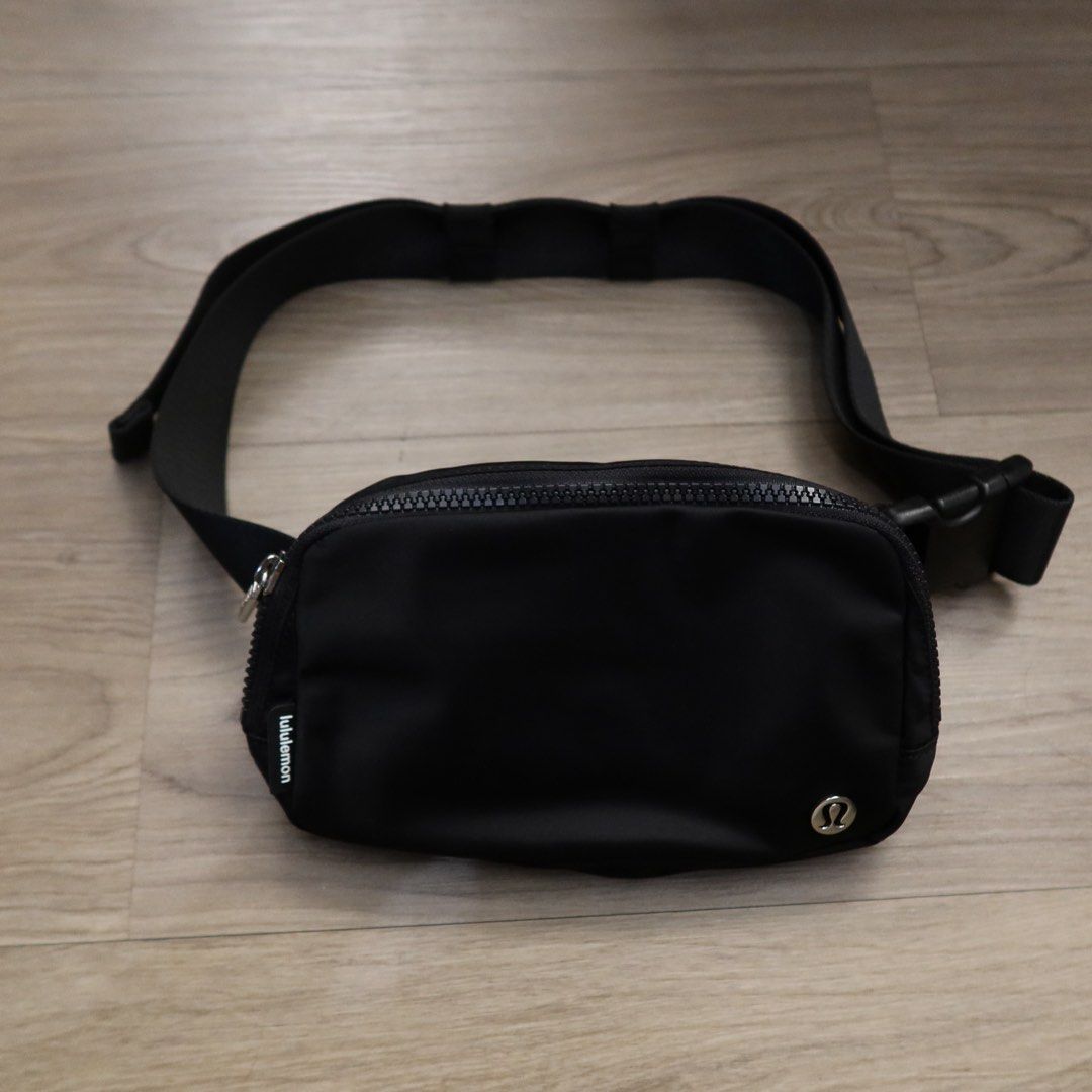 Lululemon Everywhere Belt Bag Black (Category: Belt bags, Clutches and Pouches) located in Manila. Submitted by gentlewind_62f064 (Listing ID 1469018704, Image 2). Description: - Brand: Lululemon - Style: Everywhere Belt Bag - Color: Classic Black - Material: Durable, water-repellent nylon - Dimensions: 19cm x 13cm - Features: Adjustable strap with buckle closure, exterior zip pocket, and metallic logo emblem - Interior: Clean lining with mesh sl