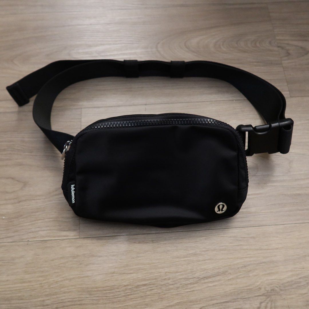 Lululemon Everywhere Belt Bag Black (Category: Belt bags, Clutches and Pouches) located in Manila. Submitted by gentlewind_62f064 (Listing ID 1469018704, Image 1). Description: - Brand: Lululemon - Style: Everywhere Belt Bag - Color: Classic Black - Material: Durable, water-repellent nylon - Dimensions: 19cm x 13cm - Features: Adjustable strap with buckle closure, exterior zip pocket, and metallic logo emblem - Interior: Clean lining with mesh sl