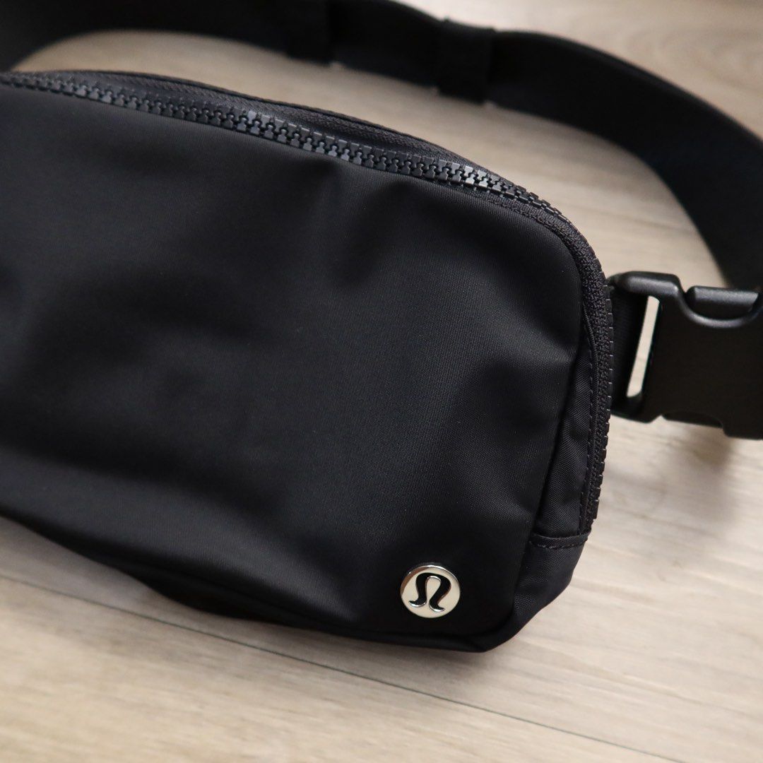Lululemon Everywhere Belt Bag Black (Category: Belt bags, Clutches and Pouches) located in Manila. Submitted by gentlewind_62f064 (Listing ID 1469018704, Image 3). Description: - Brand: Lululemon - Style: Everywhere Belt Bag - Color: Classic Black - Material: Durable, water-repellent nylon - Dimensions: 19cm x 13cm - Features: Adjustable strap with buckle closure, exterior zip pocket, and metallic logo emblem - Interior: Clean lining with mesh sl