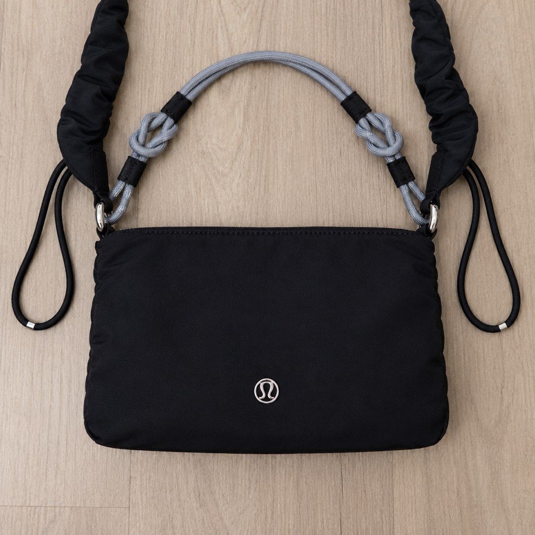 Lululemon Gathered Handle Crossbody Bag Black (Category: Cross-body Bags) located in Manila. Submitted by gentlewind_62f064 (Listing ID 1469019405, Image 2). Description: - Brand: Lululemon - Color: Black with grey knotted rope handles - Dimensions: 13 x 21 cm - Material: 100% recycled nylon body - Features: Secure zipper closure, stylish ruched strap details, and interior brand lining - Design: Clean, minimal, and versatile for daily wear.