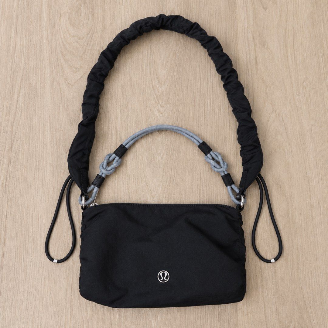 Lululemon Gathered Handle Crossbody Bag Black (Category: Cross-body Bags) located in Manila. Submitted by gentlewind_62f064 (Listing ID 1469019405, Image 1). Description: - Brand: Lululemon - Color: Black with grey knotted rope handles - Dimensions: 13 x 21 cm - Material: 100% recycled nylon body - Features: Secure zipper closure, stylish ruched strap details, and interior brand lining - Design: Clean, minimal, and versatile for daily wear.