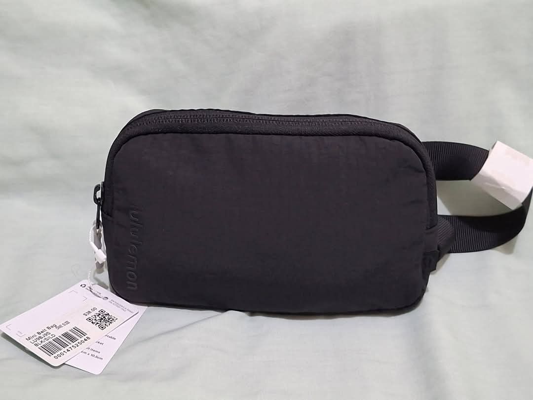 Lululemon Mini Belt Bag Black (Category: Belt bags, Clutches and Pouches) located in Manila. Submitted by closetprincess (Listing ID 1468959056, Image 1). Description: - 100% Authentic Lululemon mini belt bag in classic black - Compact size: 19cm x 10.5cm, perfect for daily essentials - Durable ripstop nylon material built to last - Features an interior mesh pocket and iconic Lululemon logo patch - Adjustable strap with secure plastic buckle clos