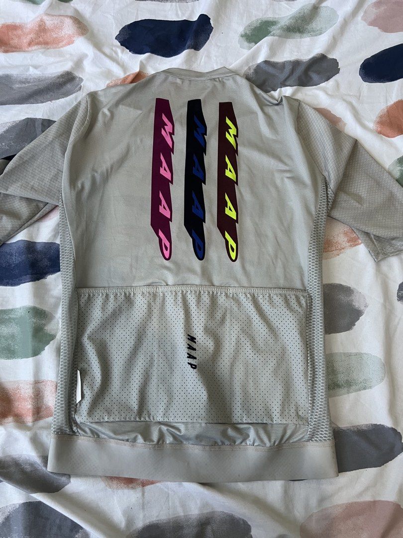MAAP Pro Fit Cycling Jersey Grey Size Large (Category: Activewear) located in Manila. Submitted by cyclinggoods (Listing ID 1469121850, Image 2). Description: - Brand/Model: MAAP Pro Fit Cycling Jersey - Color/Design: Grey with multi-colored brushstroke graphic - Size: Large - Features: Short sleeves, full front zip, three rear cargo pockets - Material: Lightweight, breathable mesh fabric - Origin: Designed in Australia, Made in Romania.