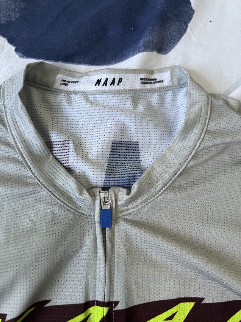 MAAP Pro Fit Cycling Jersey Grey Size Large (Category: Activewear) located in Manila. Submitted by cyclinggoods (Listing ID 1469121850, Image 3). Description: - Brand/Model: MAAP Pro Fit Cycling Jersey - Color/Design: Grey with multi-colored brushstroke graphic - Size: Large - Features: Short sleeves, full front zip, three rear cargo pockets - Material: Lightweight, breathable mesh fabric - Origin: Designed in Australia, Made in Romania.
