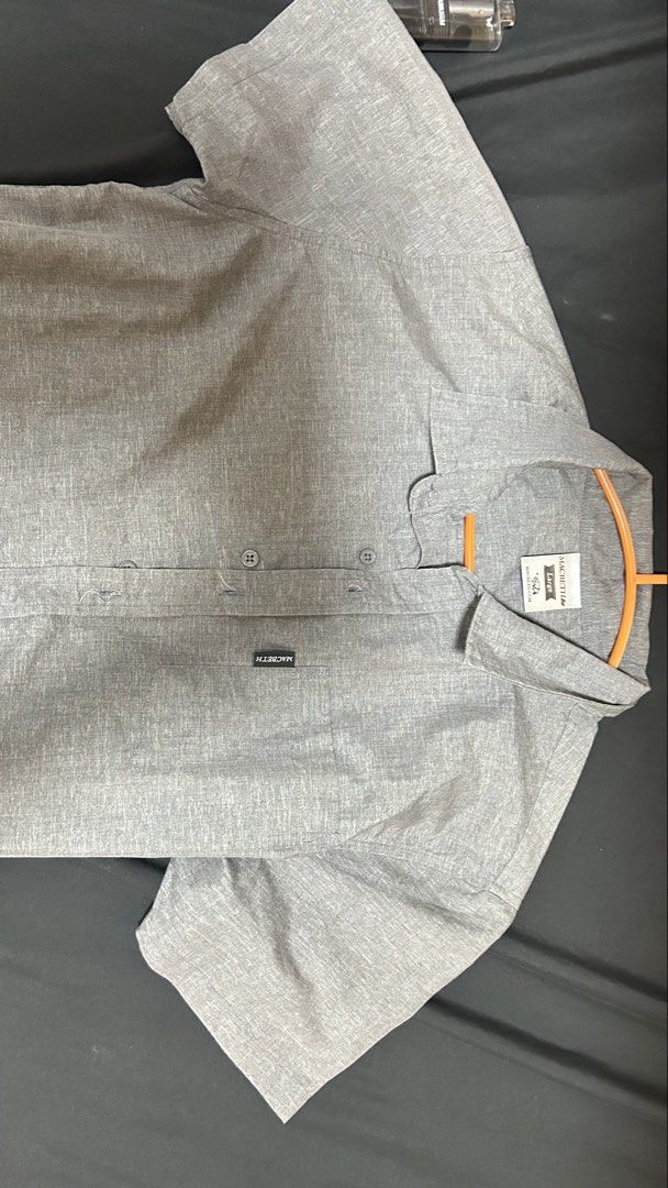 Macbeth Gray Short Sleeve Button Up Shirt Size Large (Category: Tshirts & Polo Shirts ) located in Manila. Submitted by lycheeei_ (Listing ID 1469116257, Image 2). Description: - Brand: Macbeth - Color: Gray heathered texture - Size: Large - Style: Short sleeve button-up with classic collar - Details: Front button closure, single chest pocket with brand label - Fit: Standard fit - Condition: Clean look, ideal for casual wear with denim or chinos.