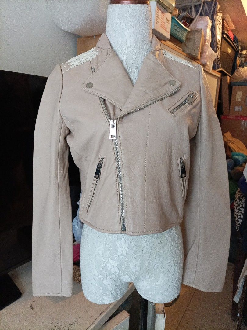 Maje Beige Leather Biker Jacket Size 38 (Category: Coats, Jackets and Outerwear) located in Pasig City. Submitted by sandacecloset (Listing ID 1468933734, Image 1). Description: - Brand: Maje - Item: Leather Biker Jacket - Size: 38 (Medium) - Color: Classic beige with a soft pale pink lining - Closure & Hardware: Asymmetric front zip with metallic hardware - Pockets: Functional zip pockets - Style Details: Notched lapels and intricate woven braid