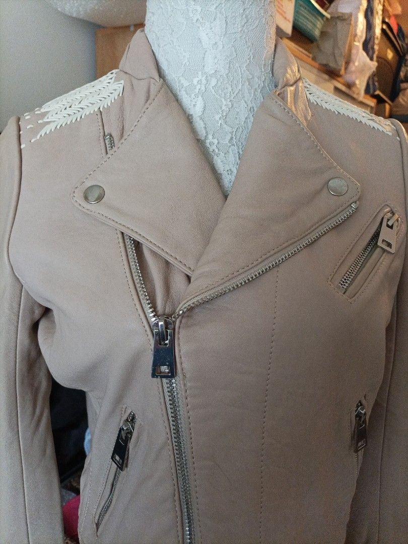 Maje Beige Leather Biker Jacket Size 38 (Category: Coats, Jackets and Outerwear) located in Pasig City. Submitted by sandacecloset (Listing ID 1468933734, Image 2). Description: - Brand: Maje - Item: Leather Biker Jacket - Size: 38 (Medium) - Color: Classic beige with a soft pale pink lining - Closure & Hardware: Asymmetric front zip with metallic hardware - Pockets: Functional zip pockets - Style Details: Notched lapels and intricate woven braid