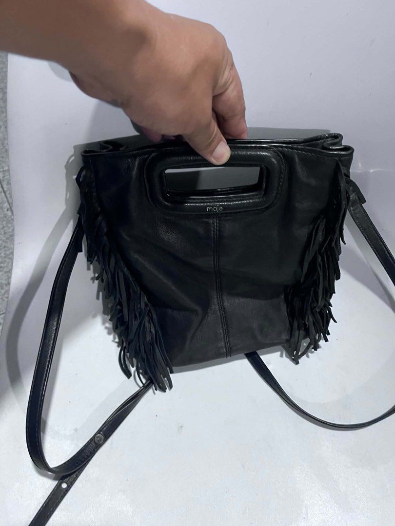 Maje Black Leather Fringe Shoulder Bag (Category: Shoulder Bags) located in Dagupan City. Submitted by fahionista1988 (Listing ID 1469044349, Image 1). Description: - Brand: Maje - Material: Supple black leather with tonal stitching - Design: Stylish fringe details on both sides - Hardware: Silver branding stamped near the handle - Straps: Structured top handle cutout plus a long adjustable shoulder strap - Details: Includes inner care tags and P