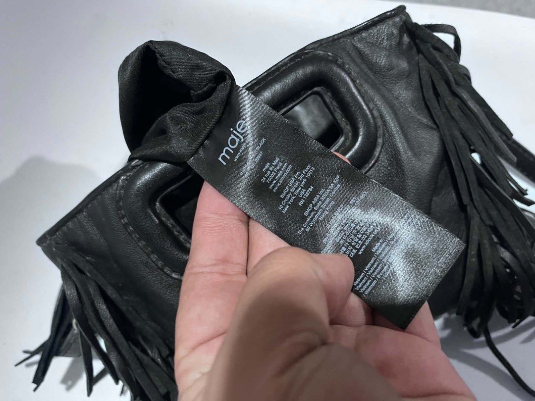 Maje Black Leather Fringe Shoulder Bag (Category: Shoulder Bags) located in Dagupan City. Submitted by fahionista1988 (Listing ID 1469044349, Image 2). Description: - Brand: Maje - Material: Supple black leather with tonal stitching - Design: Stylish fringe details on both sides - Hardware: Silver branding stamped near the handle - Straps: Structured top handle cutout plus a long adjustable shoulder strap - Details: Includes inner care tags and P