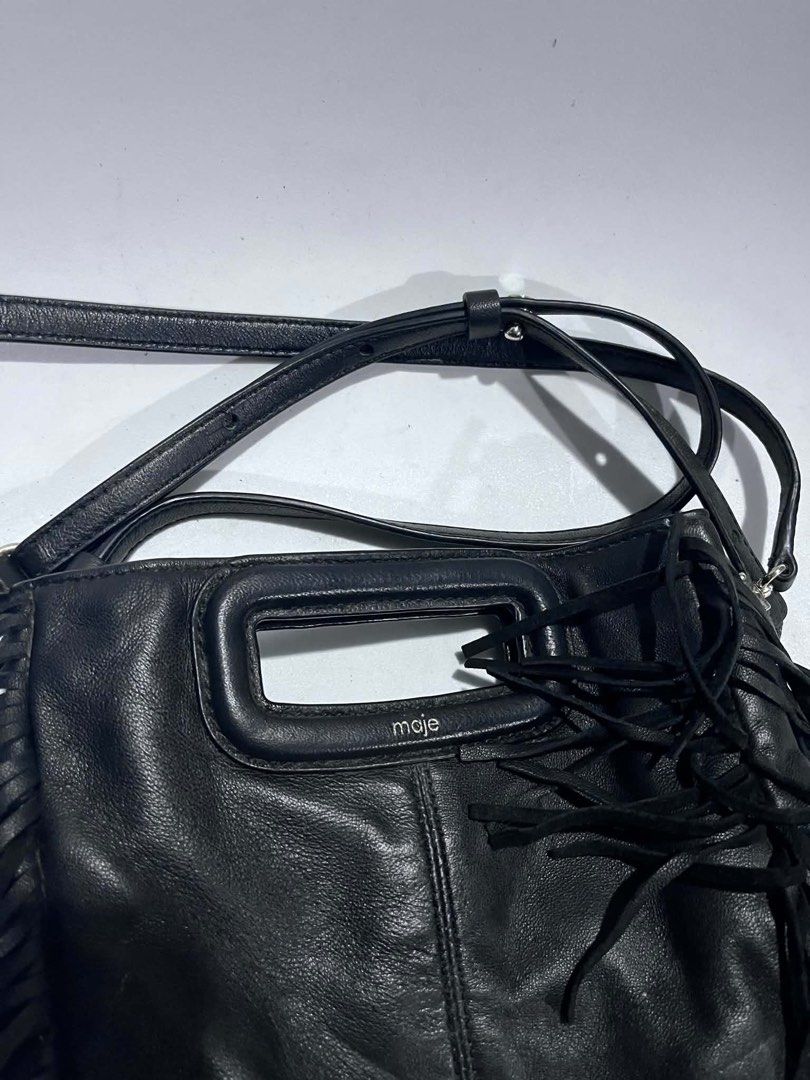 Maje Black Leather Fringe Shoulder Bag (Category: Shoulder Bags) located in Dagupan City. Submitted by fahionista1988 (Listing ID 1469044349, Image 3). Description: - Brand: Maje - Material: Supple black leather with tonal stitching - Design: Stylish fringe details on both sides - Hardware: Silver branding stamped near the handle - Straps: Structured top handle cutout plus a long adjustable shoulder strap - Details: Includes inner care tags and P