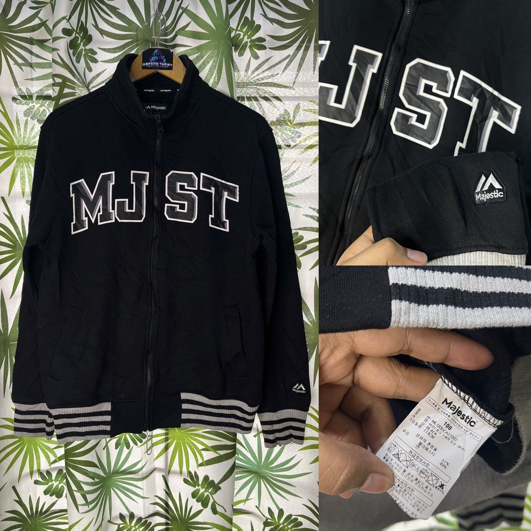 Majestic Athletic (Category: Coats, Jackets and Outerwear) located in Caloocan City. Submitted by thriftywaps (Listing ID 1468937481, Image 1). Description: - Brand: Majestic Athletic - Color: Black with large white 'MJ ST' chest lettering - Material: Comfortable cotton-polyester blend - Design: Full-zip closure, striped ribbing on collar, cuffs, and hem - Pockets: Two convenient front slash pockets - Size: 100 tag attached.